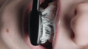Boy brushes his teeth with a toothbrush. Mouth close-up. Vertical video. - Powered by Shutterstock - Get 15% off with code: PIKWIZARD15