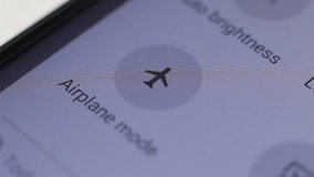 Macro close up of airplane mode button pressed on a LCD display - Powered by Shutterstock - Get 15% off with code: PIKWIZARD15