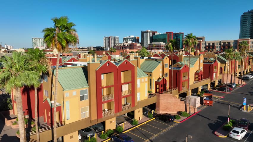 Bright adobe style apartments in Tempe, Arizona. Hayden Square Condos. Aerial establishing shot during sunset. Royalty-Free Stock Footage #1108852995