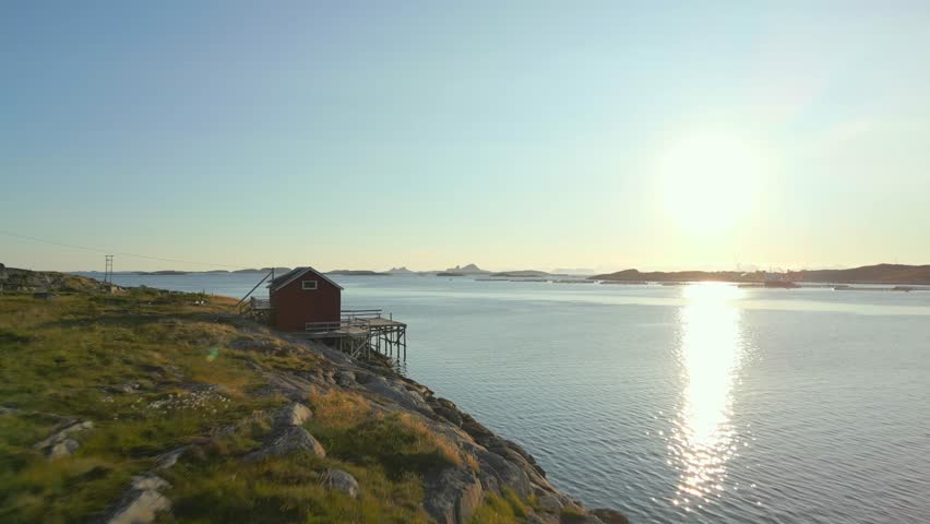 Fishing dock with a small house, situated by the calm seaside