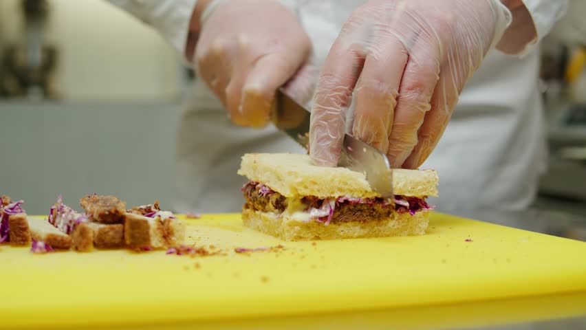 Chef cooking Katsu Sando japanese sandwich with breaded beef or pork chop, cabbage and tonkatsu sauce, traditional Japanese cuisine in restaurant. | Shutterstock HD Video #1108858311