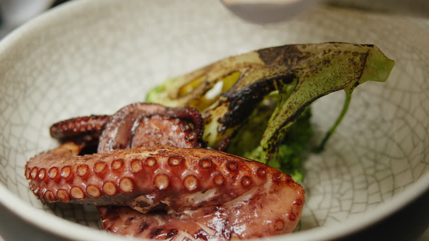 Chef cooking grilled octopus in modern restaurant, japanese cuisine, man grill seafood with boiling water, raw fresh fish for sushi sashimi, boiled steamed octopus, mediterranean restaurant, spanish | Shutterstock HD Video #1108858315