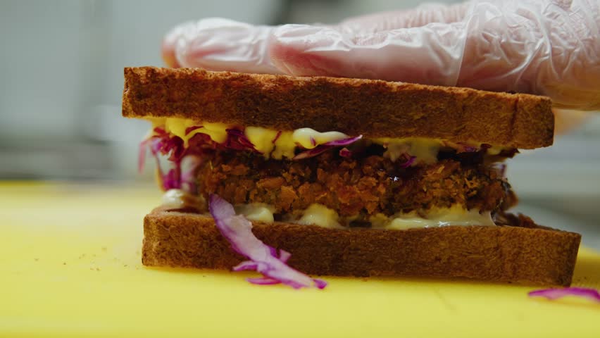 Chef cooking Katsu Sando japanese sandwich with breaded beef or pork chop, cabbage and tonkatsu sauce, traditional Japanese cuisine in restaurant. | Shutterstock HD Video #1108858327