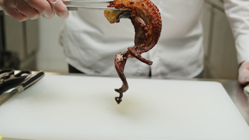 Chef cooking grilled octopus, japanese cuisine, man grill seafood with boiling water, raw fresh fish for sushi sashimi, boiled steamed octopus, mediterranean restaurant, spanish kitchen.  | Shutterstock HD Video #1108858353