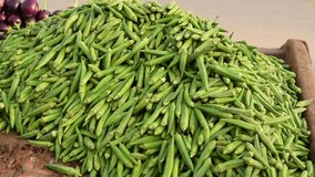 4k footage of okra vegetables on stall in vegetables market. Pile of Bright Green Okra Set out at Farmer's Market; Summerville, South Carolina. okra or Abelmoschus esculentus on a market stall.