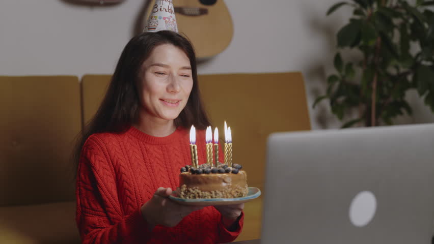 Happy Asian woman and her online friend celebrating Happy Birthday Using Laptop Video Call. Social distancing. Girl blowing candles on cake and cheers champagne glass with her boyfriend online. Royalty-Free Stock Footage #1108862993