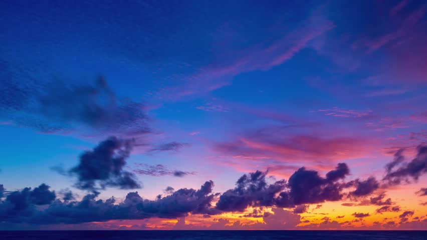 Beautiful 4K Time lapse of Majestic sunrise sky over sea landscape,Amazing light of nature cloudscape beach sky and Clouds moving away rolling,Colorful sunset or sunrise cloud timelapse background