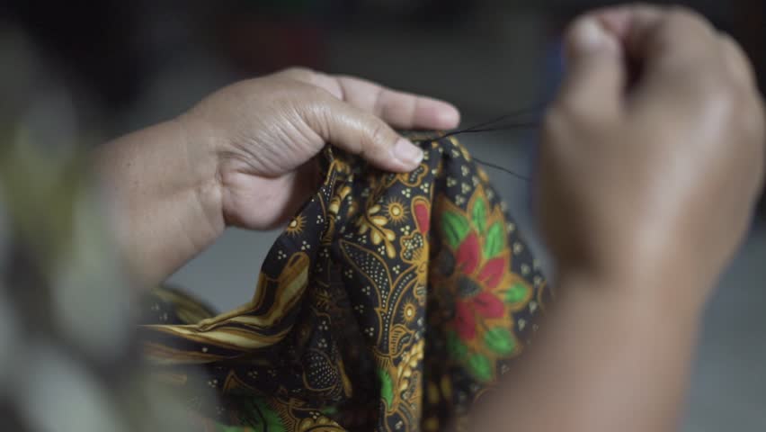 Woman hands sewing batik traditional fabric textile Royalty-Free Stock Footage #1108872239