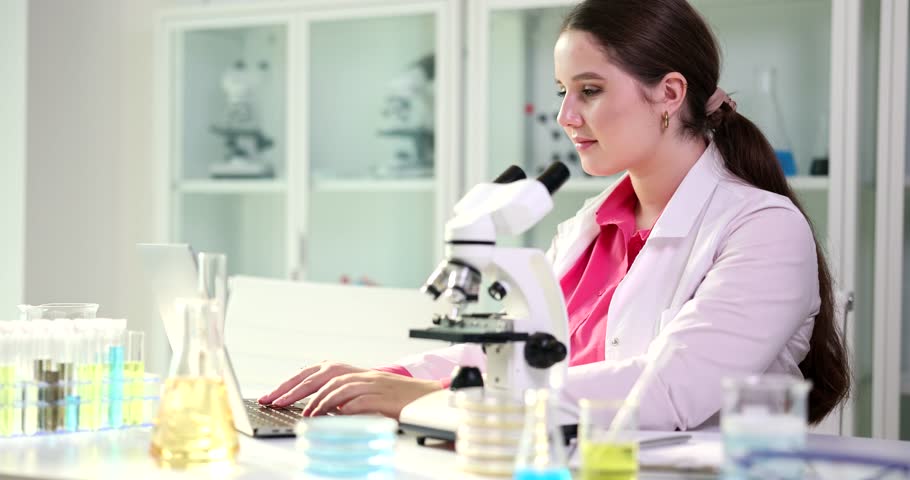 Scientist or student using laptop computer and microscope. Science future and forensic laboratory | Shutterstock HD Video #1108875925