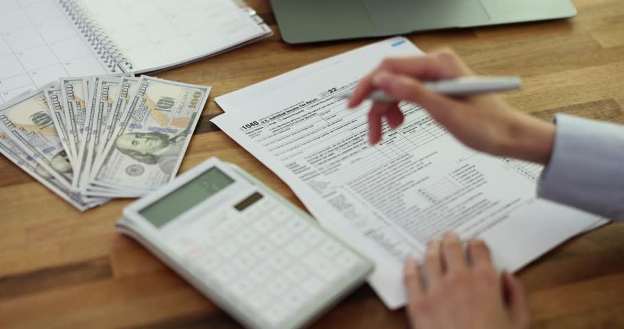 Tax deduction form and calculator. Concept of paying taxes and filing tax return Royalty-Free Stock Footage #1108875985