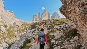 Group of friends with backpacks hiking trail path and trekking Tre Cime di Lavaredo Dolomites mountain. Travel exploring Alps, Dolomites, Italy
 - Powered by Shutterstock - Get 15% off with code: PIKWIZARD15