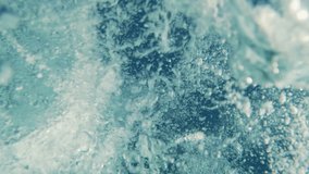 Vertical video, Many air bubbles under seething surface of waves, underwater shot