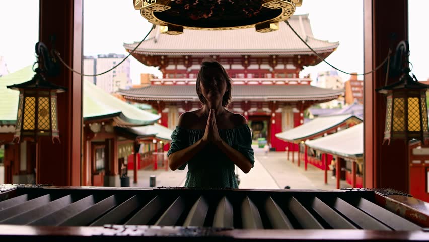 woman praying in a Buddhist shrine in Japan, Sensoji temple in Tokyo, famous Japanese buddhist temple tourism in Japan. High quality 4k footage Royalty-Free Stock Footage #1108883093