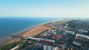 Skegness, Lincolnshire, comes to life in this aerial video, highlighting its vibrant beach town, amusements, iconic pier, and a summer evening vibe.