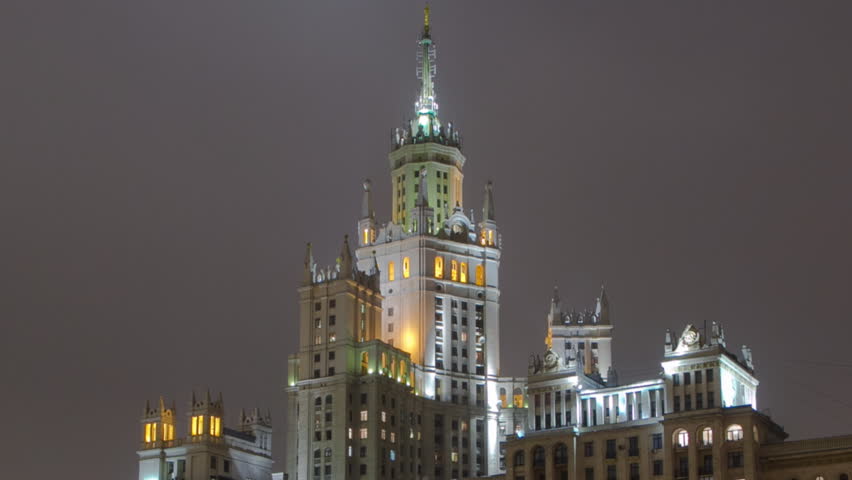 Famous Building on Kotelnicheskaya Waterfront at Night: One of the Seven Sisters Buildings in Moscow. Hyperlapse with Reflection in Moscow River. Russia