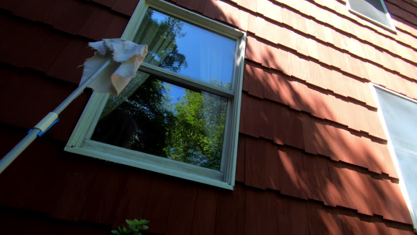 Woman cleaning house window from the outside in the spring | Shutterstock HD Video #1108895417