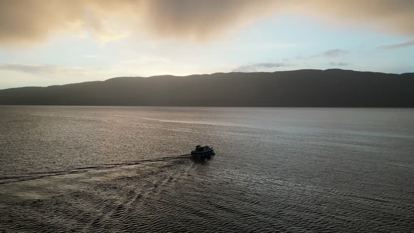 The boat traveling on Loch Ness in the early morning.