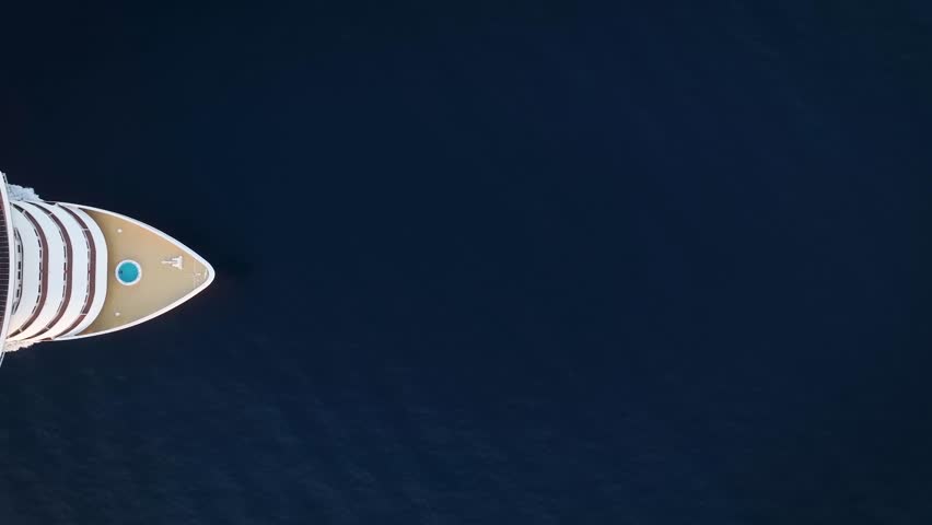 Aerial top down view of a passing by cruise ship traveling over blue ocean during sunset time Royalty-Free Stock Footage #1108899457