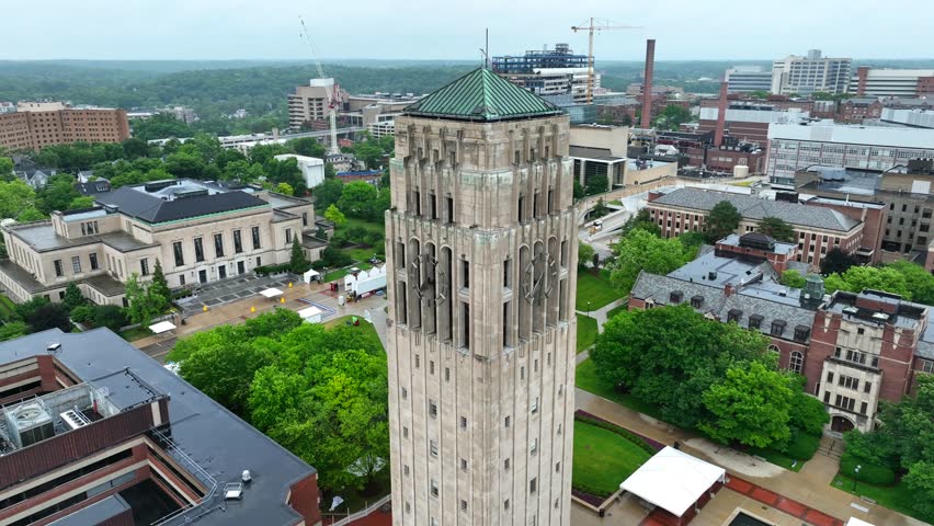 Beaumont Tower at University of Michigan. Aerial orbit on rainy summer day on college campus.