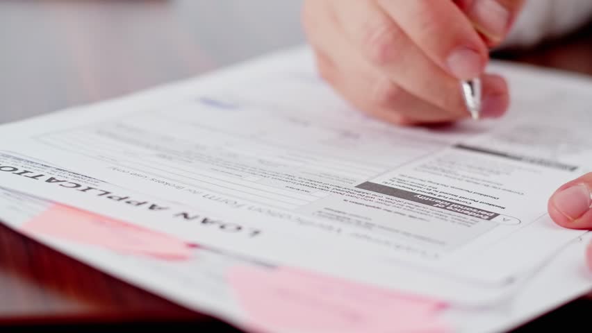 Man signing loan application, to take mortgage loan or a loan for starting a business. Paperwork for a bank to make a deal with partners. Royalty-Free Stock Footage #1108900907