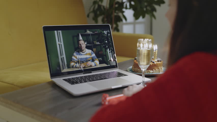 Happy Asian woman and her male man friend celebrating Happy Birthday Using Laptop Video Call. Social distancing. Girl blowing candles on cake and cheers champagne glass with her boyfriend online. Royalty-Free Stock Footage #1108902655