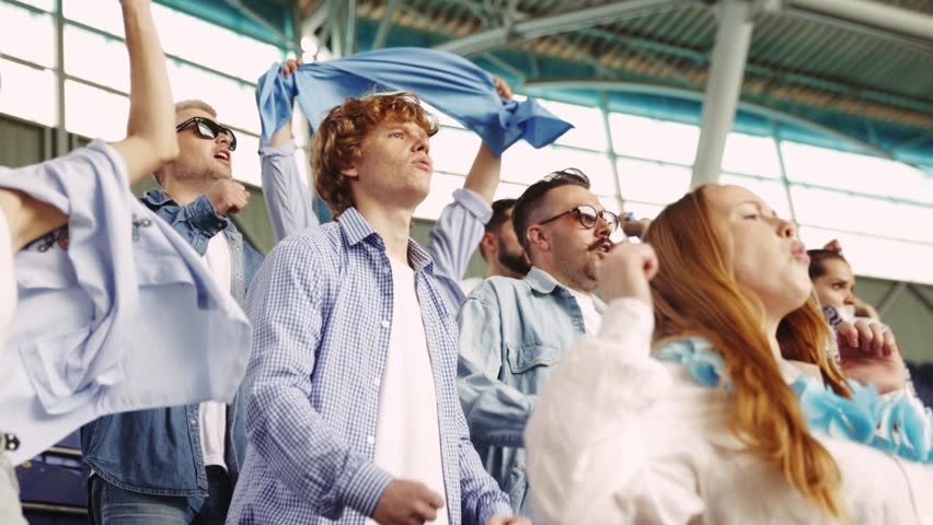 Group young people, friends, sport fans at stadium,cheering emotional up favorite sport team during game. Concept of sport, world cup, team, event and competition, emotions, championship, betting