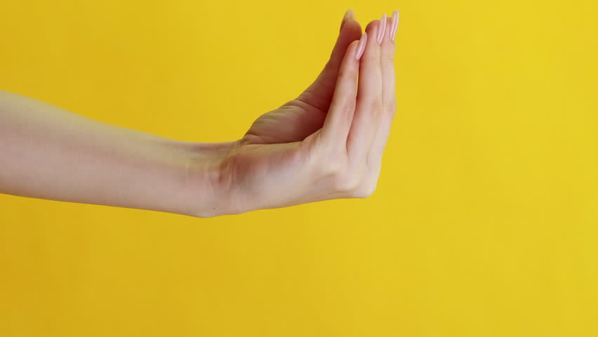 Vertical video. Household product advertising. Cleaning play. Socks show imitation. Woman hand quarreling with arm protective gloves victory sign isolated on yellow background. Royalty-Free Stock Footage #1108905215