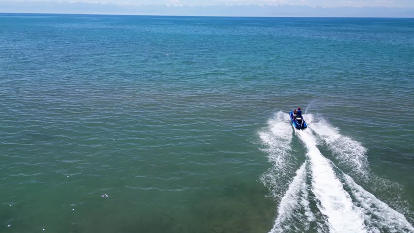 Aerial view of man riding personal watercraft in the lake Royalty-Free Stock Footage #1108909131