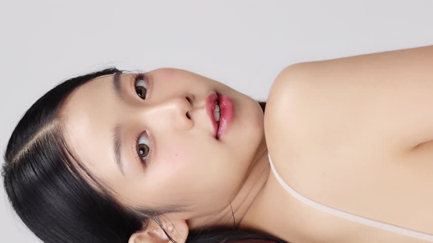 Close up face of young beautiful young Asian woman with healthy and fresh skin. Vertical beauty footage. Royalty-Free Stock Footage #1108909395