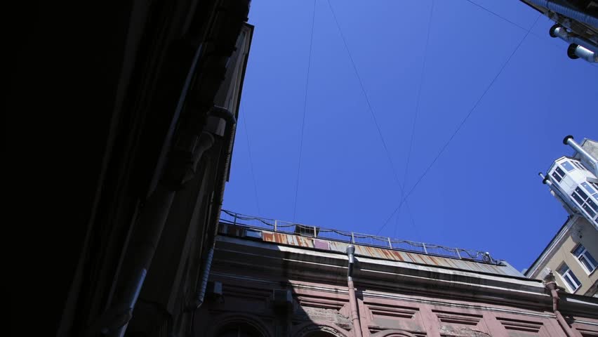 Low angle view of typical well shaped back yard in a sunny summer day in Saint-Petersburg city, Russia. Clear blue sky. Real time handheld video. General architecture theme. | Shutterstock HD Video #1108909769