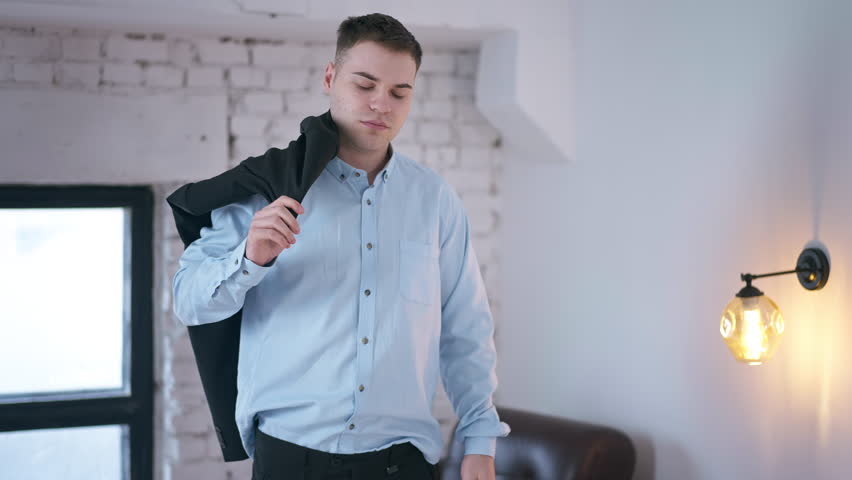 Live camera follows tired man falling forward on comfortable bed in bedroom. Tracking shot portrait of Caucasian exhausted freelancer at home indoors | Shutterstock HD Video #1108911195
