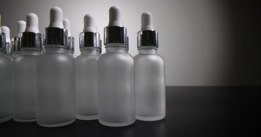 Set of white glass cosmetic jars for cream and serum on gray background. Bottles for cosmetics | Shutterstock HD Video #1108919289