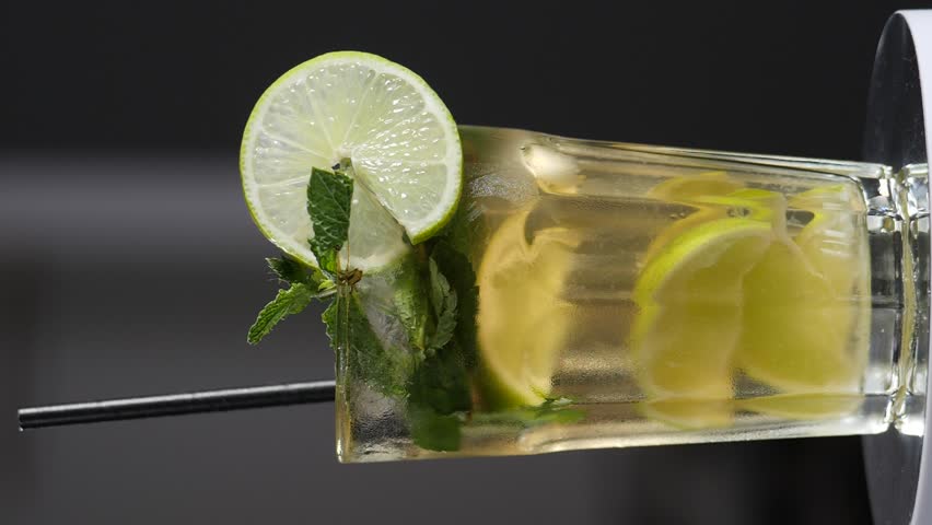 Classic mojito cocktail rotating. Slow motion. Vertical footage. Barman Combining Ingredients to cook mojito cocktail. Summer refreshing beverage. Making fizzy mojito lemonade for weekend party | Shutterstock HD Video #1108919811
