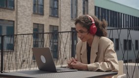 Woman Listening to Audio Book or Online Course in Headphones