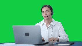 Stressed Indian call center girl talking to customer through call Green screen