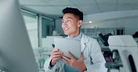 Scientist, tablet and computer for research, data analysis and typing test results or laboratory report. Doctor, science expert or happy asian man with medical or digital software for biotechnologyの動画素材