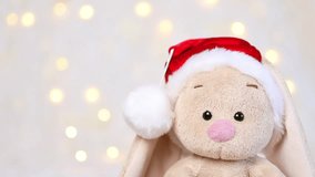 Toy bunny on a background with Christmas lights. - Powered by Shutterstock - Get 15% off with code: PIKWIZARD15