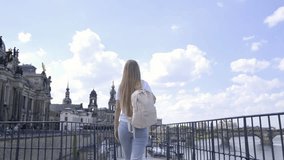 A young European woman is traveling in the city of Dresden, Germany in the summertime. 