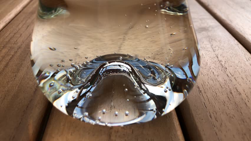 Vanishing bubbles in sparkling fizzy lemonade in transparent glass. Close up detail. | Shutterstock HD Video #1108940685
