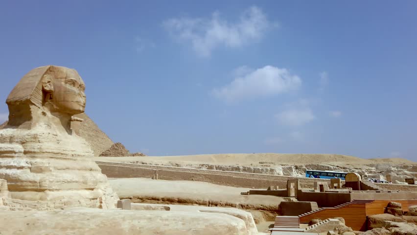 Great Sphinx of Giza opposite Pyramid of Khufu at background. Giza plateau, Greater Cairo, Egypt