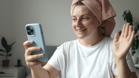 Video call. Cheerful young woman talking with friends on cell phone at home. High quality FullHD footage