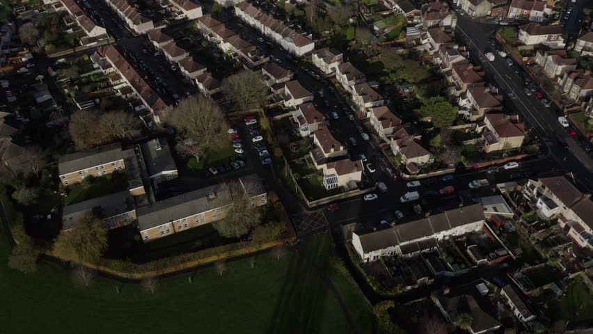 Aerial of English suburban houses with city centre in the background on a sunny morning Royalty-Free Stock Footage #1108946027