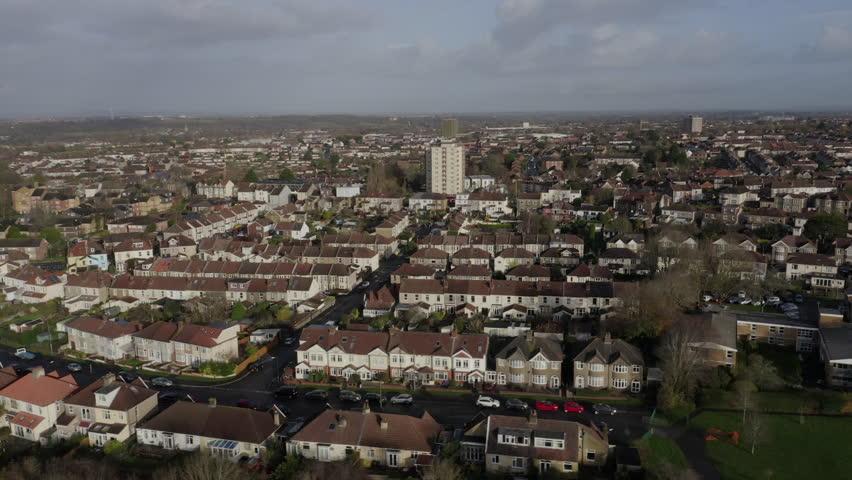 Tracking aerial shot of mixed residential housing on outskirts of Bristol, UK on a sunny morning Royalty-Free Stock Footage #1108946045