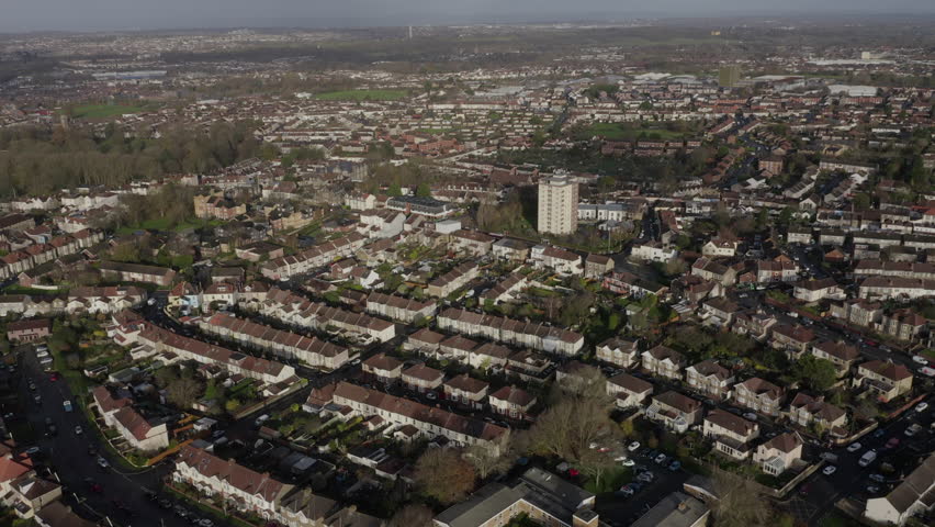 Tracking aerial of mixed residential housing on outskirts of Bristol, UK on a sunny morning Royalty-Free Stock Footage #1108946049