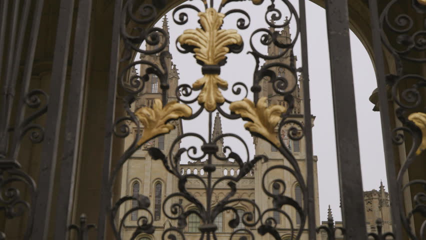 Oxford University All Souls college building exterior with towers behind ornamental bar closed gates. Education in UK and historical landmarks concept 