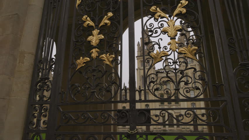 Panning view beautiful exterior gates ornamental decorations. Closed Oxford university behind gate bars. Architecture british schools education in UK concept