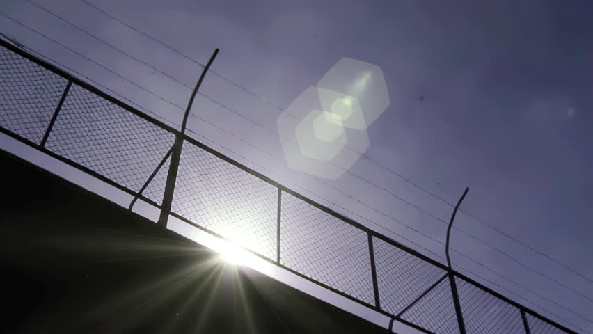 Barbed Wire Fence Silhouette on Prison Wall, Maximum Security Facility - 4K