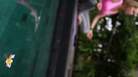 Frangipani flowers floating in the swimming pool and mid adult woman doing yoga at background, outdoors shot - Powered by Shutterstock - Get 15% off with code: PIKWIZARD15