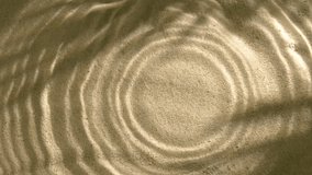 Close-up rain drops falling and splashing in water, leaf shadow on sand texture - Powered by Shutterstock - Get 15% off with code: PIKWIZARD15