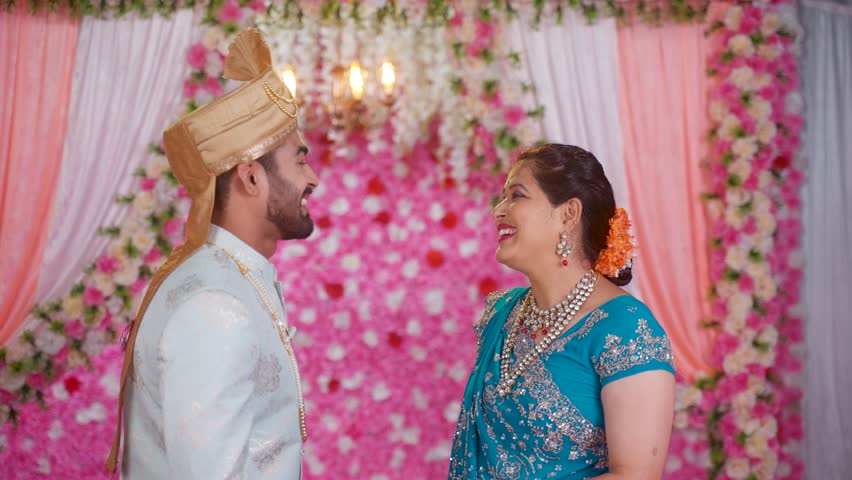 Proud Mother embracing his son as groom during Marriage celebration on stage - concept of Proud Moments, Emotional relationship and family bonding. Royalty-Free Stock Footage #1108956039